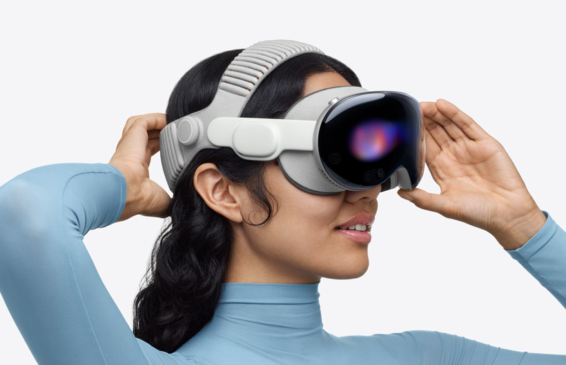 A person putting on Apple Vision Pro with the Dual Knit Band