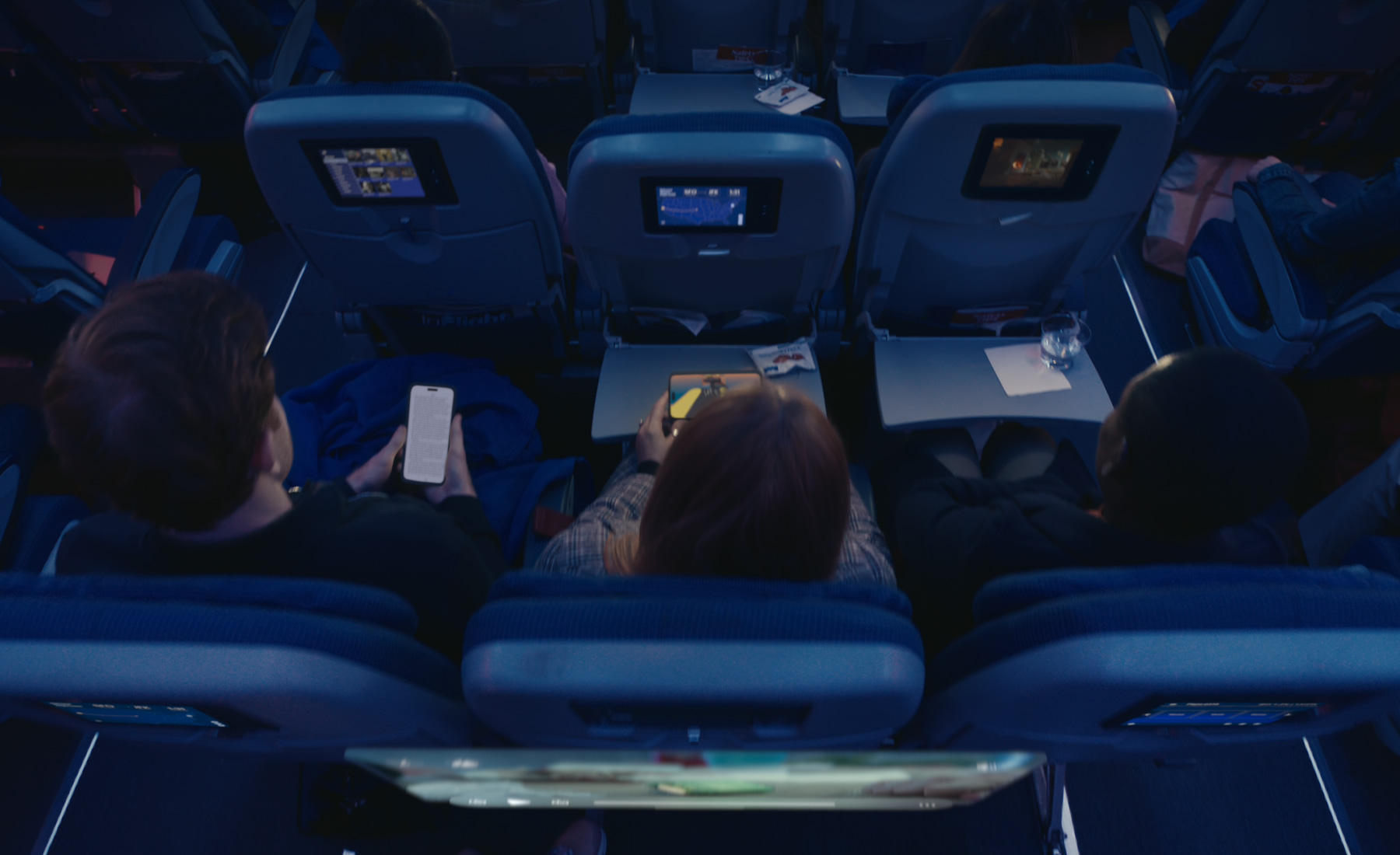 A user watching a movie in a cinema environment on an airplane, an immersive underwater video, and playing a game.