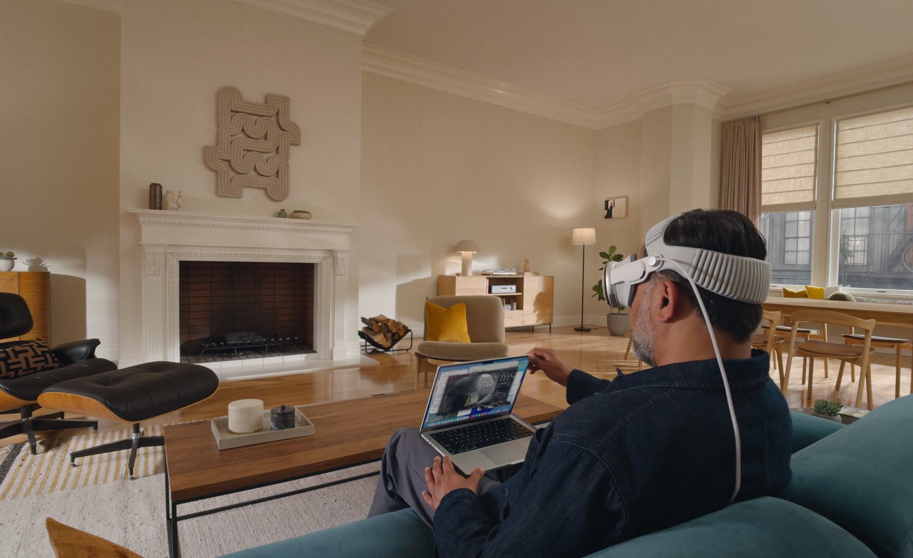 A user multitasking across floating app windows and a Mac display in a large virtual workspace.