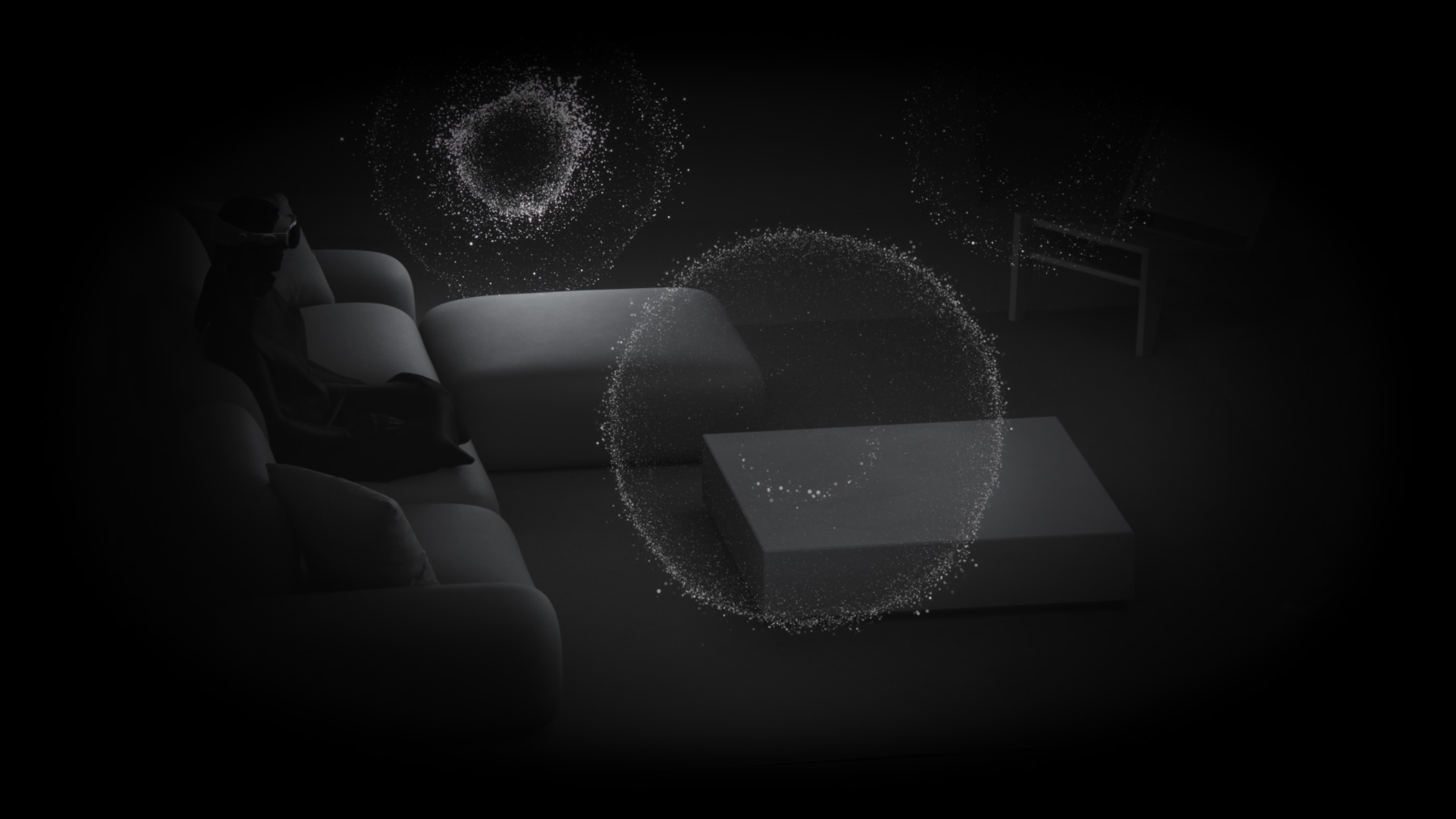 A dark room with Spatial Audio visualized as glowing particles around a person wearing Apple Vision Pro